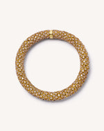 18k yellow gold twister luxe bracelet with champagne diamonds on white background.