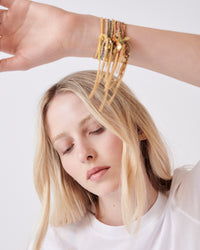 Carolina Bucci Lucky bracelets stacked on a wrist