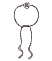 18k black gold diamond-cut chain, hand braided with grey silk, and a pavé grey diamond incrusted scorpio zodiac symbol on a mother of pearl medallion on a white background