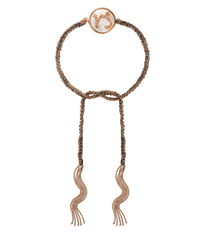 18k rose gold diamond-cut chain, hand braided with grey silk, and a pavé grey diamond incrusted capricorn zodiac symbol on a mother of pearl medallion on a white background