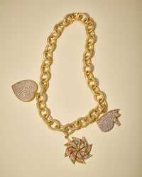 18k yellow florentine frosted finish gold 1885 40cm necklace chain, connected with 18k yellow gold cuore, girandola and the eye pavé pendant on cream background