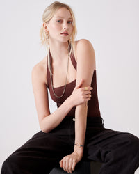 18k gold 80 cm discoball necklace modelled with 18k yellow gold florentine frosted finish huggies links lucky bracelet and 18k yellow and rose florentine frosted finish rcuff rings