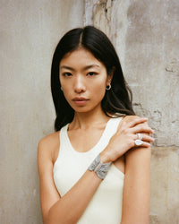 18K white gold and silk 5 cm woven bracelet modelled with 18k white golf thick and pear cut rings and 18k white gold huggy earrings