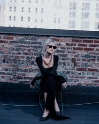 Soho gold necklace styled on model's neck