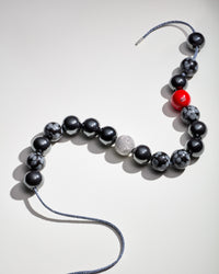 Tribeca downtown necklace including snowflake obsidian and hematite semi precious spheres, big apple red coloured enamel spheres and 18k white gold florentine frosted finish sphere