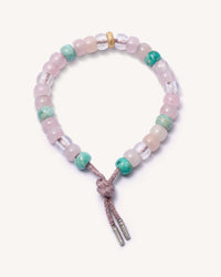 Palme beach forte beads bracelet with heather pink coloured lurex cord w/18k white gold caps and 18k yellow gold florentine frosted finish bead