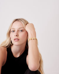 18k yellow florentine frosted finish gold forte got lucky bead bracelet modelled with large 18k yellow gold large drop earrings
