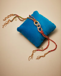 18k gold lucky bracelet 1885 links presented on blue velvet cushion