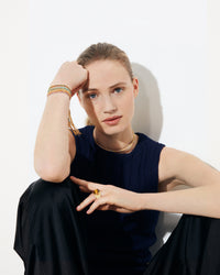 18k yellow gold open beaded choker on model styled with 18k gold lucky bracelet collection