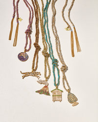 18k Yellow Gold Jaguar, Volcano, Cabina, Good luck pinecone and Blueberry pendant connected to Multi-coloured lucky 18k yellow gold bracelets