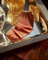 18K yellow gold and silk 5 cm woven bracelet on reflective tray