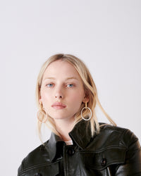 18k yellow florentine frosted finish gold small oval hoops with 18k white and rose gold large hoops on model 