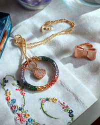 18k rose florentine frosted finish gold tutto per te ring presented with Discoball necklace with cuore pavé pendant and shiny rainbow twister luxe bracelet