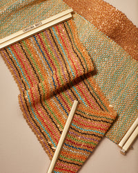 18k yellow gold 6cm rainbow striped woven bracelet presented with turquoise silk melange yellow, and pink all gold woven bracelet