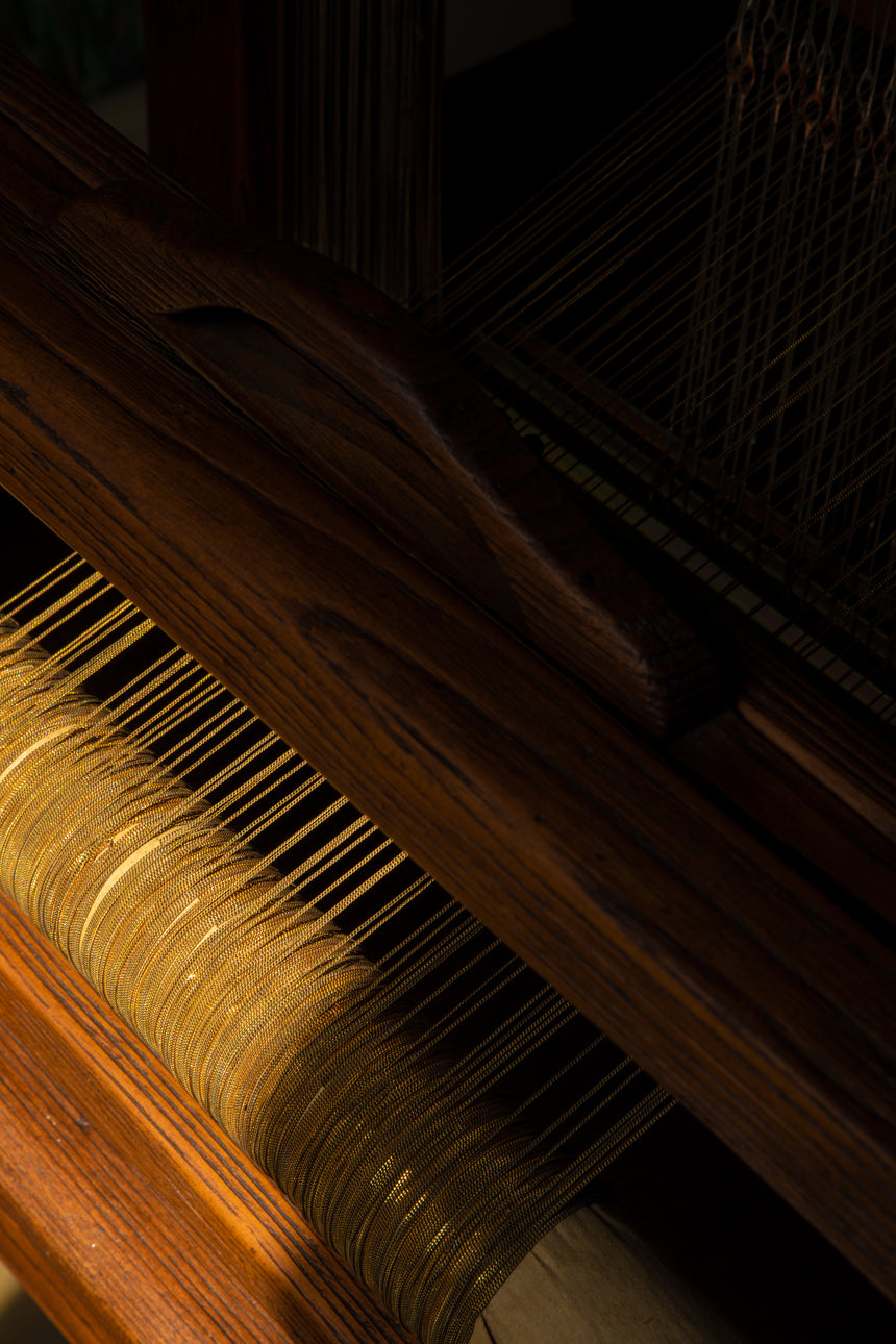 The Woven loom in our Florence atelier – a centuries-old loom originally designed to weave textiles, but adapted to weave gold and silk threads.