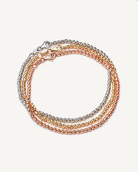 18k yellow, white and rose gold discoball bracelet set on white background