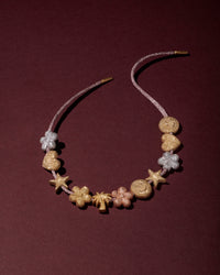 18k florentine frosted finish forte got lucky beads necklace on heather pink lurex tie cord with 18k yellow gold caps. 