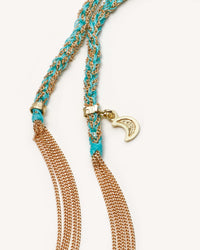 close up of 18k yellow gold lucky wisdom necklace on white background