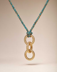 18k yellow gold lucky sprezzatura necklace with 3 18k yellow florentine frosted finish gold links on cream background