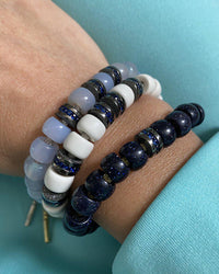 18k black gold dark blue sapphire beads presented on blue goldstone, magnesite and chalcedony forte beads bracelets 