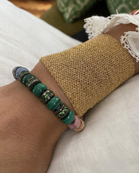 18k black florentine frosted finish gold precious bead with green tsavorite with forte beads bracelet and 18k yellow woven gold bracelet