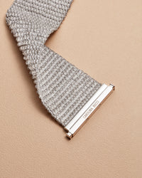 close up 18k white gold beaded 4 cm woven bracelet on cream background