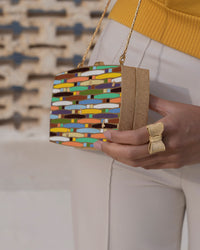 18k yellow florentine frosted finish gold woven rainbow clutch bag with multicoloured enamel modelled with 18k yellow florentine frosted fish gold tutto per te ring