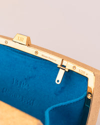 close up of 18k yellow florentine frosted finish gold woven rainbow clutch bag with multicoloured enamel with blue velvet interior