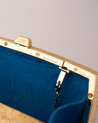 18k yellow florentine frosted finish gold woven wishes clutch bag with layered enamel blue velvet interior.