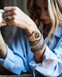 18k white gold Twister Luxe bracelet encased in pavé white diamonds modelled with 18k yellow gold initial labradorite ring and twister luxe collection