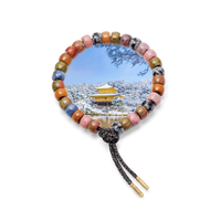 Kyoto forte beads bracelet with storm lurex tie cord with 18k yellow gold caps on white background