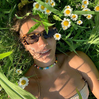 Margherita forte beads Necklace with moon lurex tie cord and 18k yellow gold caps modelled in an open field